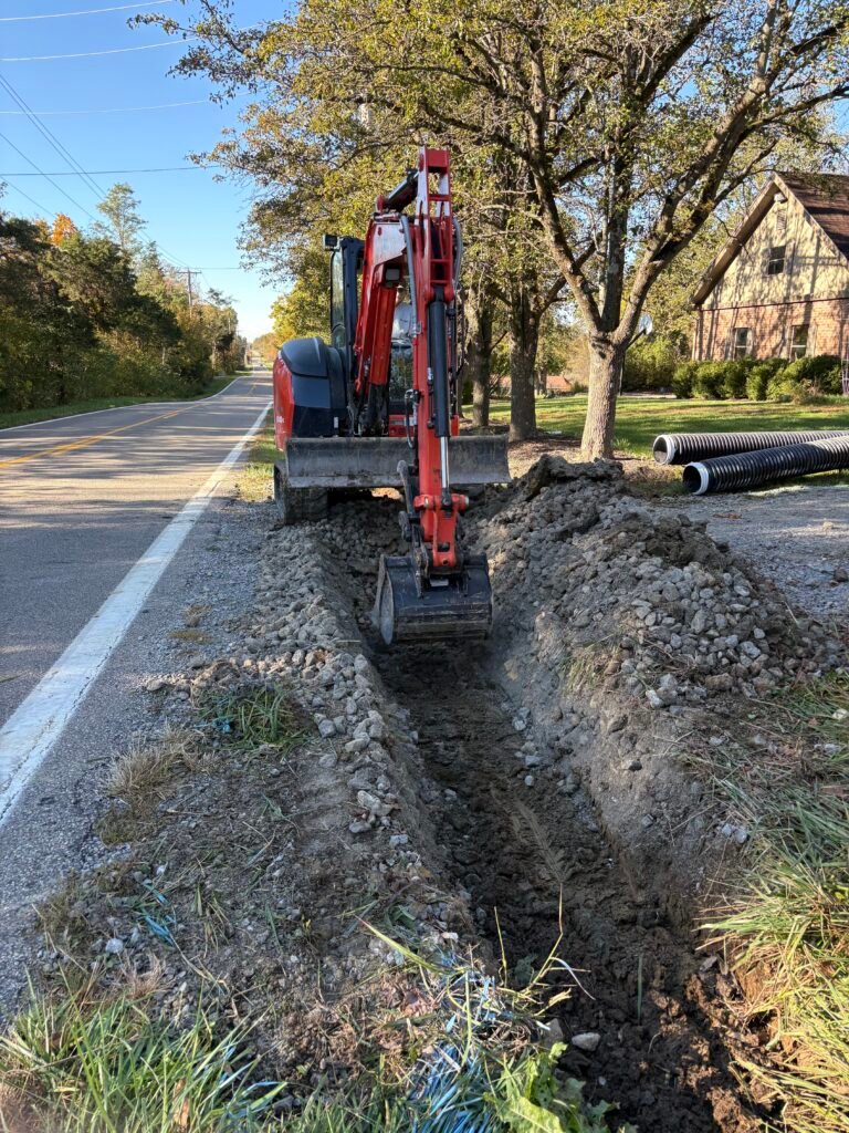 Culvert installation Cincinnati Ohio, Excavator digging culvert ditch in Cincinnati. culvert trenching Cincinnati