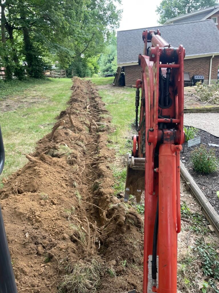 Land Trenching Cincinnati Ohio, Excavator digging trench lines in Cincinnati. Cable trenching Cincinnati